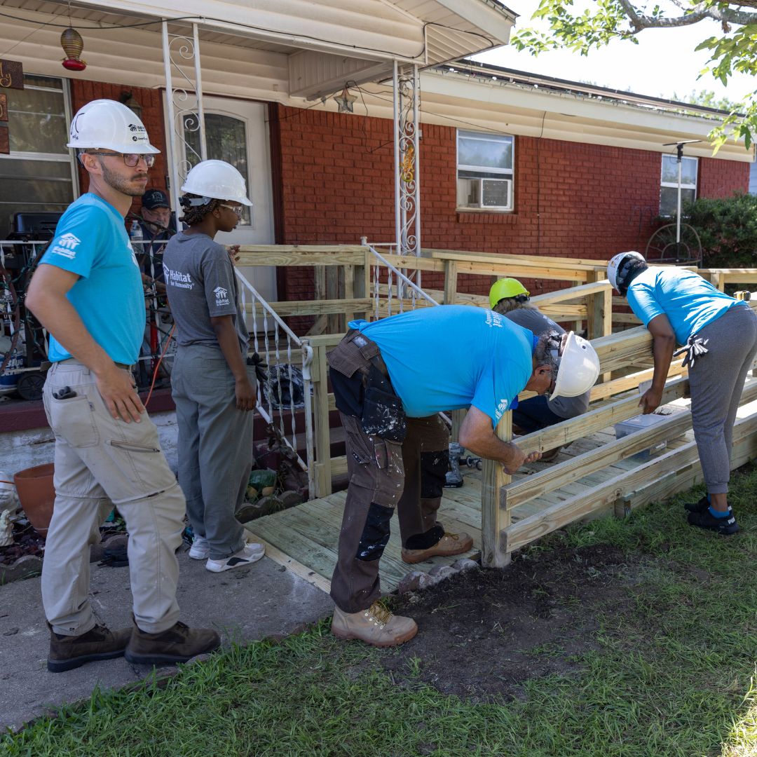 group of people constructing an accessibility ramp