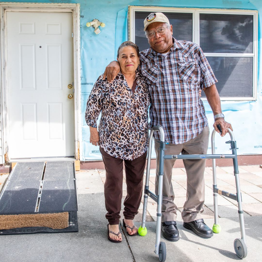 two people standing in front of a home